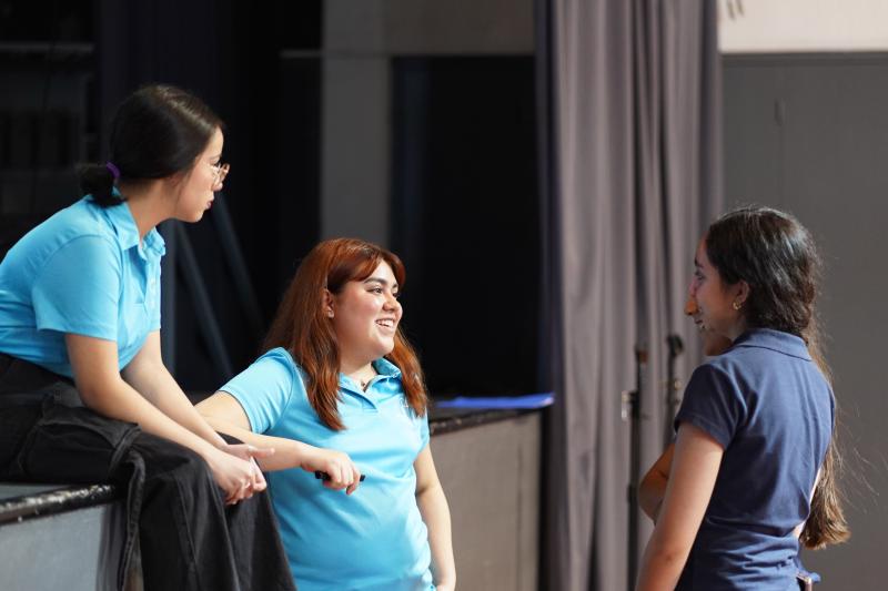 SHDNA core team members Yannina (left) and Karla (right) speak to students at Colegio Guadalajara del Sagrado Corazón