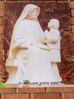 Statue of Madeleine Sophie Barat talking to a child