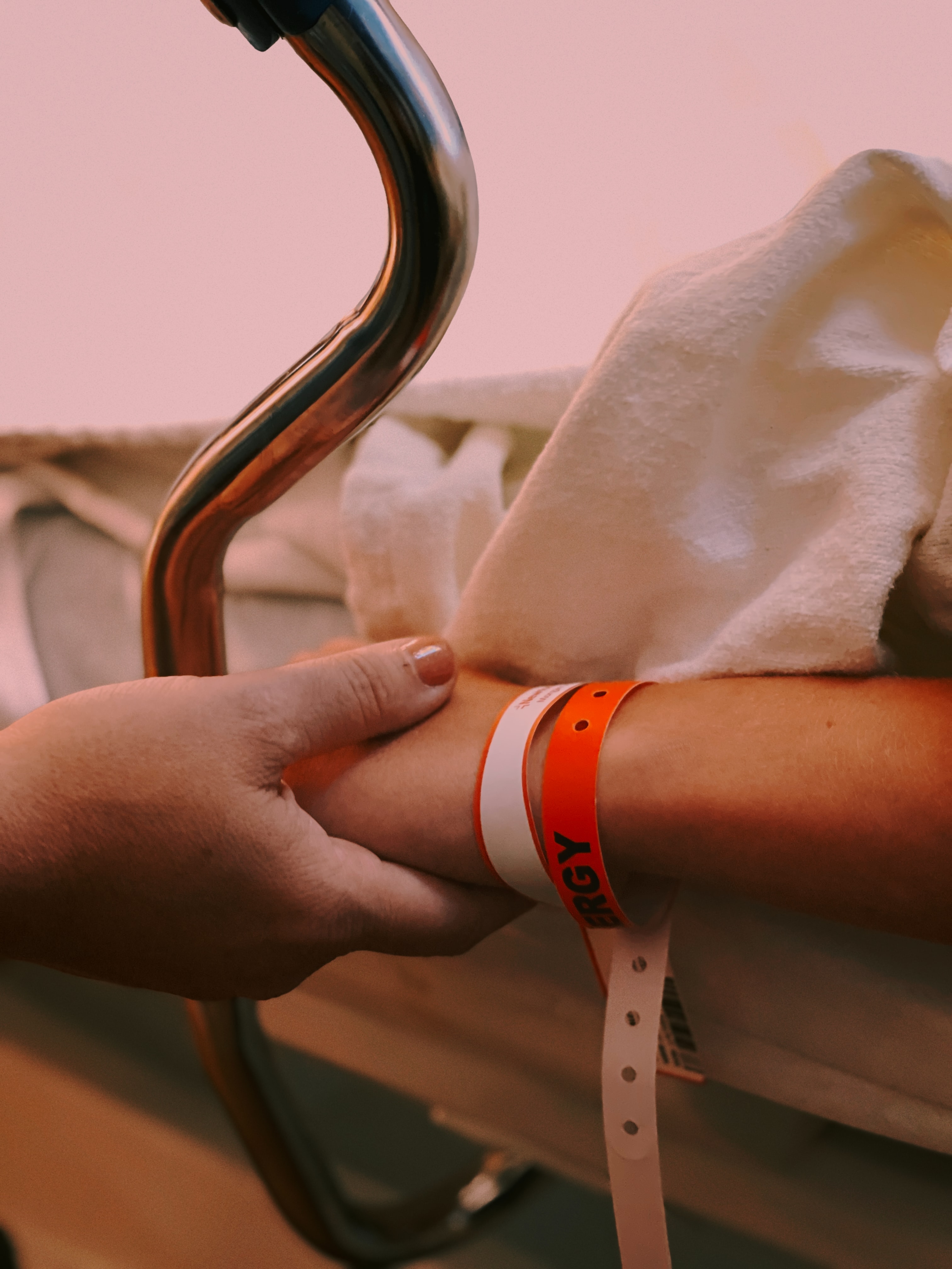 Photo of hand holding in hospital: Jon Tyson via Unsplash